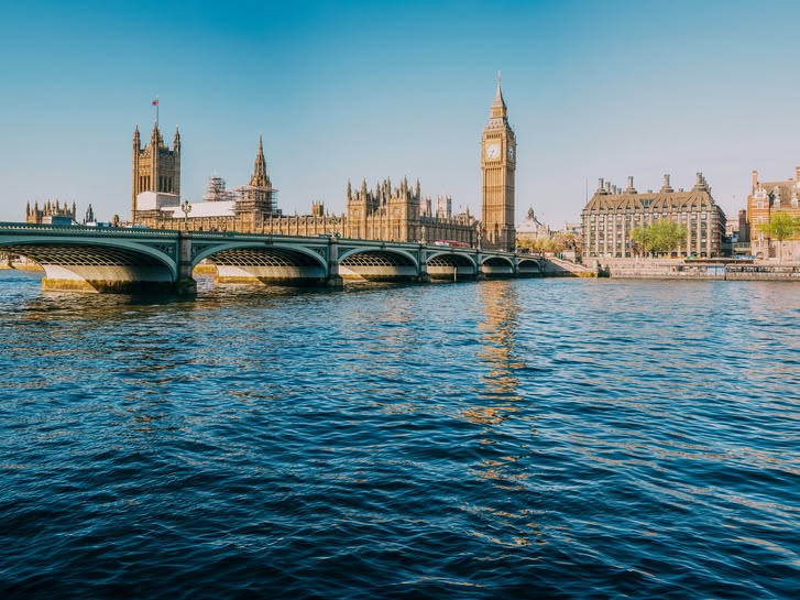 View of the River Thames with Westminster Bridge and the Houses of Parliament in London, UK.