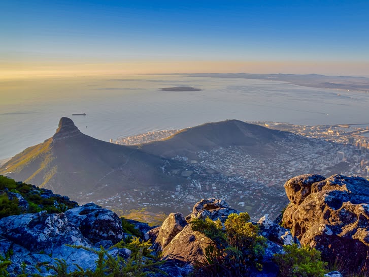 Aerial view of Cape Town, South Africa, with Lion’s Head and Table Mountain at sunset.